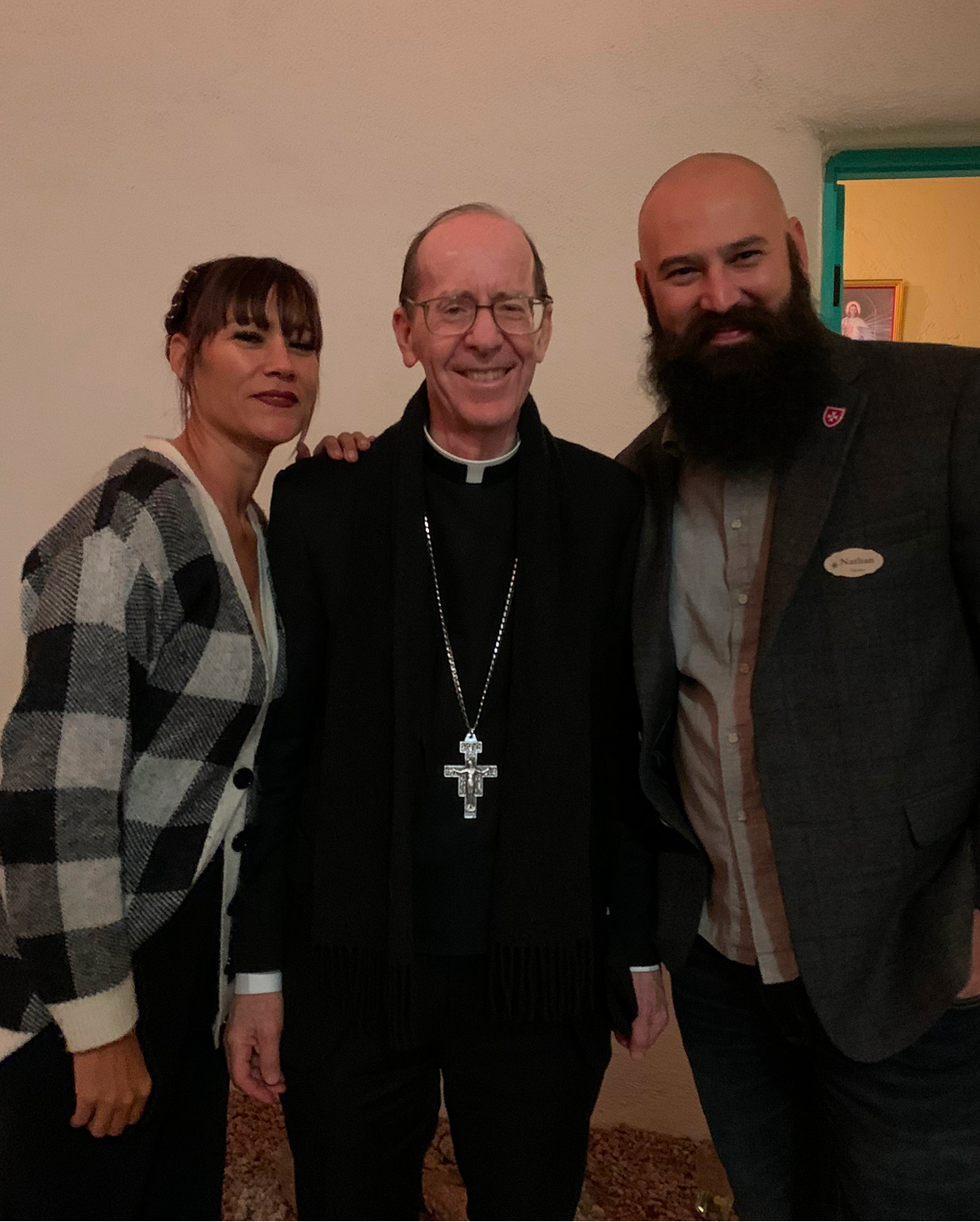 Nathan with his wife and a bishop
